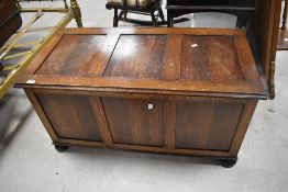 A reproduction oak three panel blanket box 51cm x 101cm x 48cm