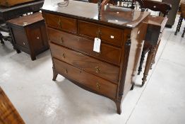 An attractive Edwardian mahogany chest of two over three cockeaded drawers, each with cruciform