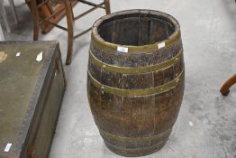 A coopered oak barrel, of typical but elongated form, open at the top 65cm