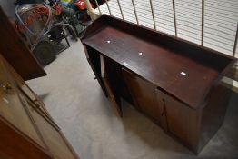 A stained mahogany clerks or stationary cupboard, of oblong form with two central fielded panel
