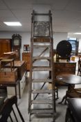 A pair of tall vintage wooden decorators step ladders, of traditional design