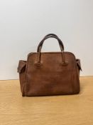 An antique Norris leather handbag, in tan leather with window-pane grid pattern debossing, side