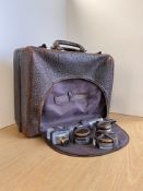 An antique travel suitcase and vanity in textured brown pigskin, grass hardware and covered