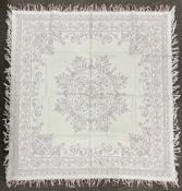 An rare handmade antique Welsh quilt or tablecloth, having blue and white threads woven into a
