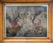 An antique framed and glazed woolwork tapestry, depicts a man telling a story to a woman and three