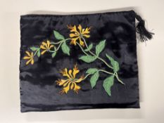 Two 20th century vintage clutch purses or pyjama wallets with padded walls, one black satin with