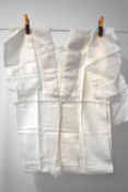 A rare unused children's shroud, in cream satin and brushed fabric with lace edging.