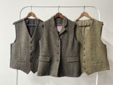 Three Harris Tweed waistcoats in brown and dark green herringbone wool, including a Glenalmond of