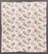 An antique Durham floral quilt in pink and green floral fabric with blush reverse panel,