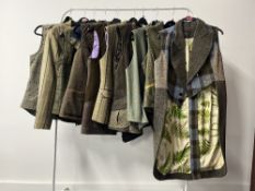 Assorted womens' country pursuit coats and waistcoats, in neutral to khaki woolen plaids and tartan,