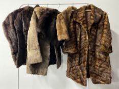 Assorted fur garments to include two stoles, two capes, a silk lined hand warmer / muff and two