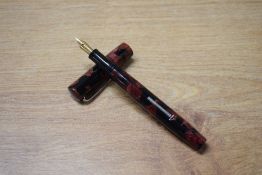 A Mabie Todd & Co Jackdaw lever fill fountain pen in Rose and Black marble having Jackdaw 14CT