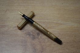 A Waterman lever fill fountain pen with 9ct 375 gold engine turned barrel and cap having Waterman