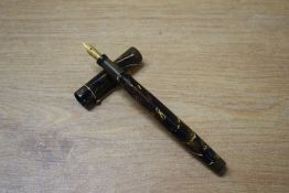 A Mabie Todd & Co Swan L205 47 leverless twist fill fountain pen in Black and Gold mottled with