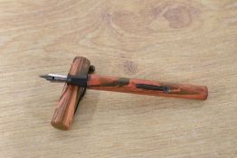 An un named lever fill fountain pen in rippled Red and Black Hard Rubber having Warranted 1st