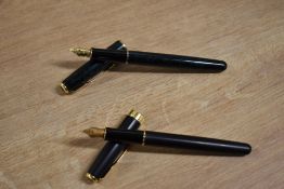 Two Parker Sonnet converter fill fountain pens. O in Matte Black with Gold trim having Parker nib,