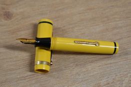 An Eagle Pencil Co USA lever fill fountain pen in Yellow with single band flat cap having 14K nib