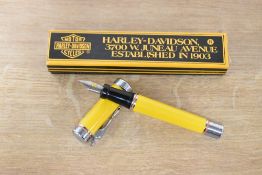 A boxed Harley Davidson converter fill fountain pen in Mandarin Yellow having Harley Davidson