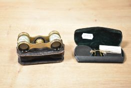 A small pair of early 19th-century brass opera glasses, having original leather pop-close case; sold