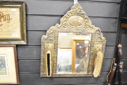 An early 20th-century Dutch-style brass-mounted shoe polishing mirror, featuring an arched top, a