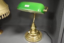 A contemporary Bankers Desk Lamp by Artech lighting, featuring a green glass shade and gilt metal