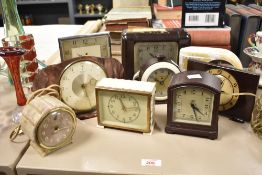 An interesting group of nine early 20th-century bakelite mantel clocks, each of differing design and