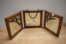 A 19th-century oak tri-fold vanity or shaving mirror, featuring an embossed faux leather backing