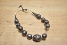 A late 19th to early 20th-century Omani white metal ball necklace, featuring hollow decorative