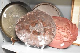 Four early to mid 20th-century bakelite or U.D.A plastic decorative plates, to feature a Art Deco-