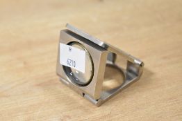 A small early 20th-century British metal folding magnifying glass, designed to be self-standing,