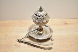 A 19th-century Omani white metal incense burner set, featuring an intricate flower-formed finial and