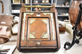 A late Victorian brass mounted oak coal scuttle, of traditional sloped front form with tubular brass