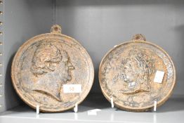 A pair of 19th-century cast metal uniface portrait profile bust medallions, to include a Queen