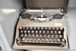 A mid 20th-century Empire Aristocrat portable manual typewriter, marked to front, 28cm x 28cm,