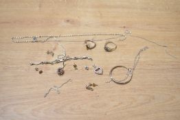 A small assortment of broken silver and white metal jewellery, including neck chains, ring
