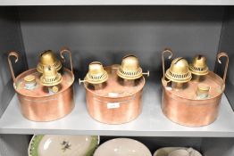 Three late 19th to early 20th-century British copper and brass double burner oil lamps, often used