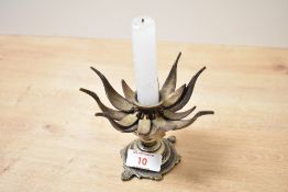 An early 20th-century brass and copper lotus flower candle holder, having articulated petals upon