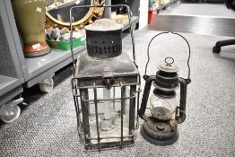 A late 19th to early 20th-century metal railway paraffin lamp/candle lantern; sold with a German