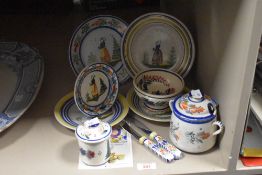 A collection of French Quimper (Henroit) pottery, comprising bowls, plates, lidded pots and two