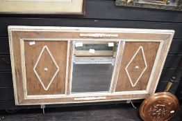 A large late 20th-century panelled wooden wall mirror, having a light wood finish and decorative