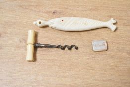 A 19th-century hand carved ox bone fish-formed needle case; sold with a miniature bone handled