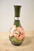 A 20th-century Moorcroft Pottery 'Hibiscus' vase, featuring peach tube-lined floral decoration to an