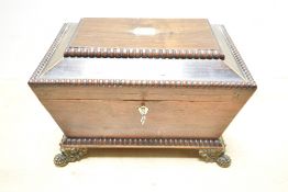 A Victorian mahogany jewellery box of sarcophagus form, featuring a monogrammed shield to the top;