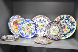 A quantity of 20th-century Spanish hand decorated ceramic plates, featuring a selection of
