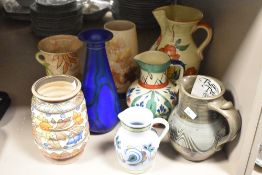 A selection of 20th century pottery jugs and vases, eight in total, to include Charlotte Rhead for