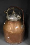 An early 20th-century Alfa-Laval-style copper and brass milking churn, featuring a swing handle