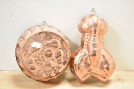 Two 20th-century copper jelly moulds, to feature a lobster example and a fruit basket-style example,