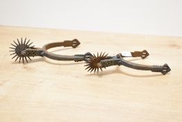 A pair of small late 19th-century South American, Chilean iron 'huasos' spurs, featuring hand etched