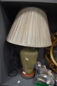 A tall contemporary studio pottery lamp base, of baluster form, featuring an olive green and rust