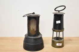 Two late 19th to early 20th-century metal and brass miners’ safety lamps, to include a Davy lamp,